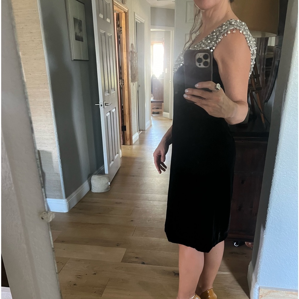 Beautiful black velvet dress. Nice detail around shoulders and back .